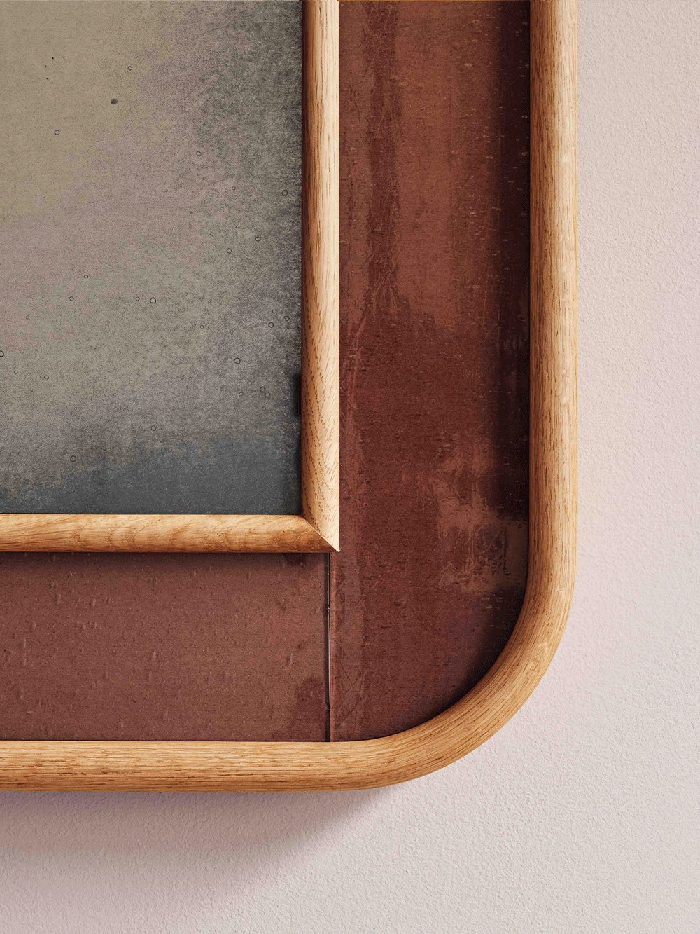 Wooden picture frame with copper glass on a neutral background.