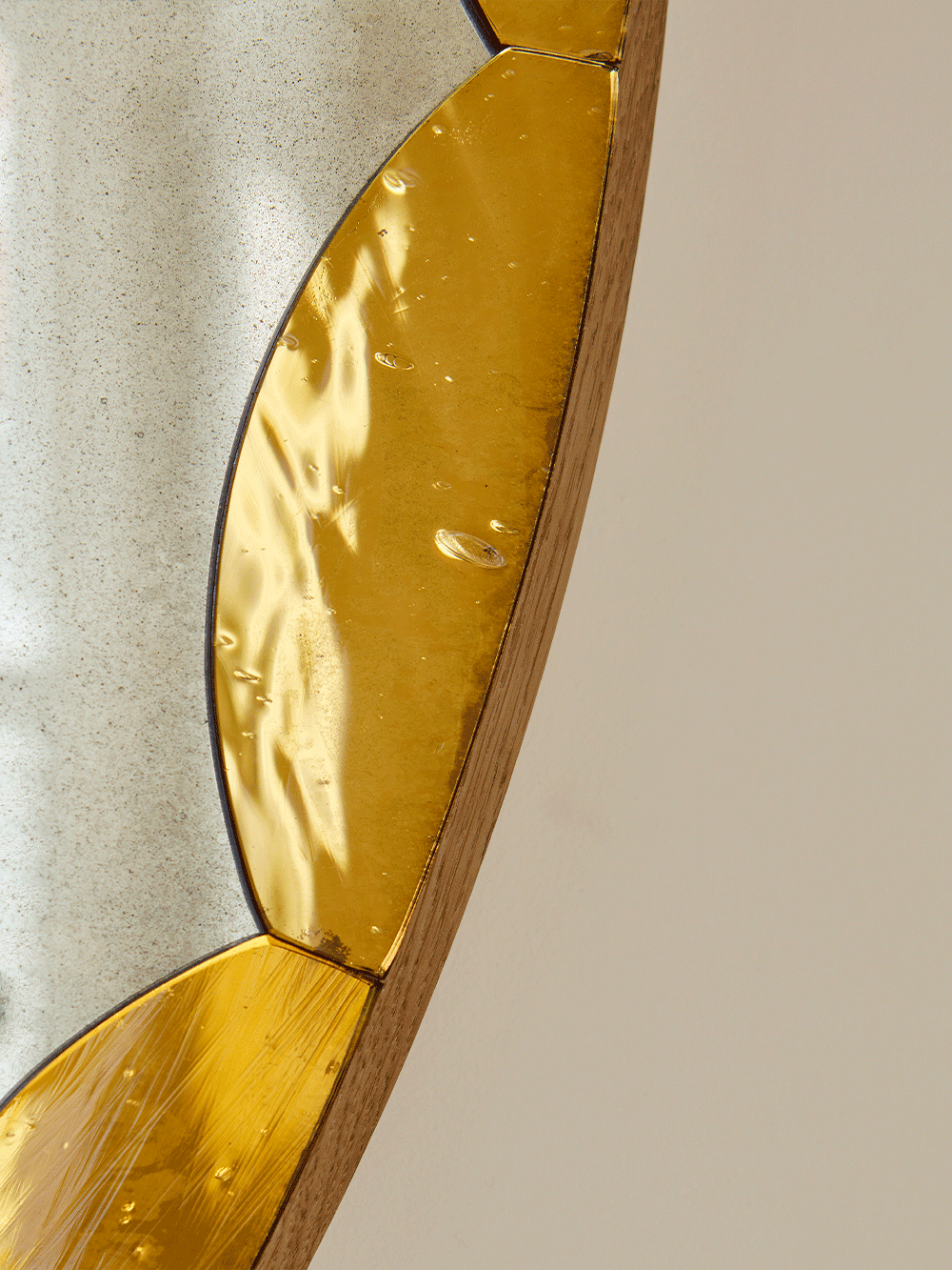 Close-up of a decorative wall mirror with a gold frame.