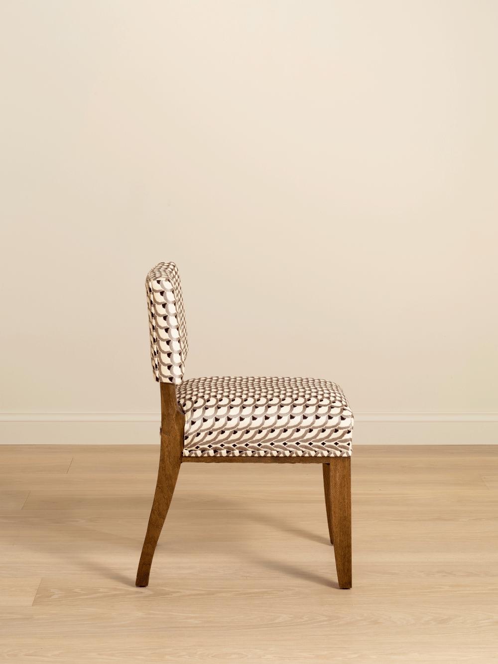 Chair with woven patterned seat and backrest on a beige background. 
