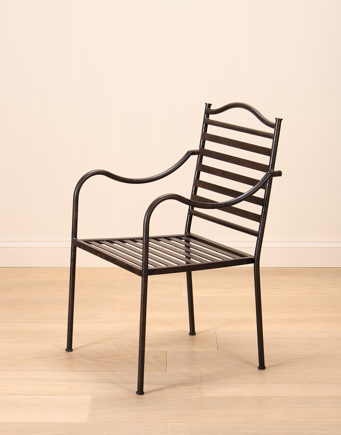 Steel chair frame on a wooden floor and beige background. 