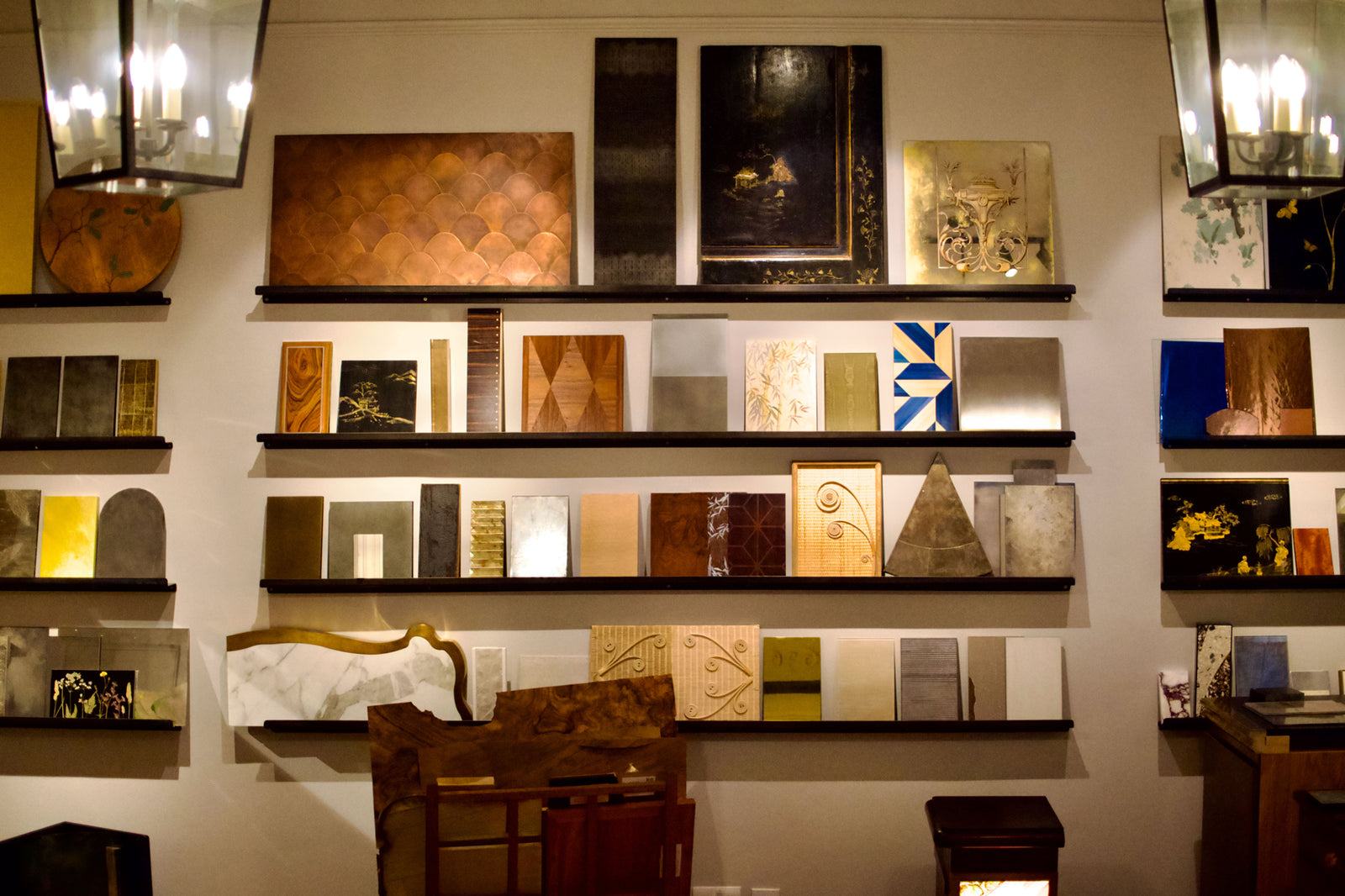 Wall display of various material samples on shelves.