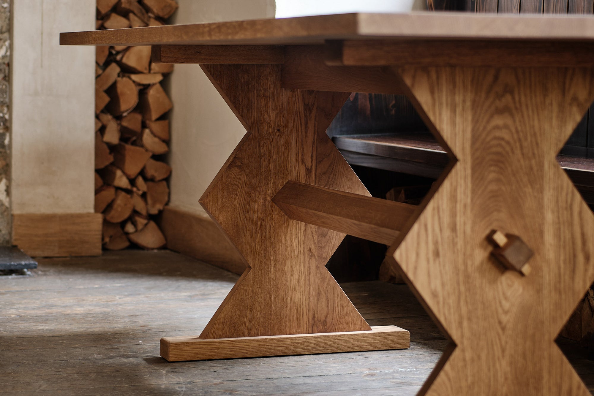 Wooden table with geometric design in a rustic setting.