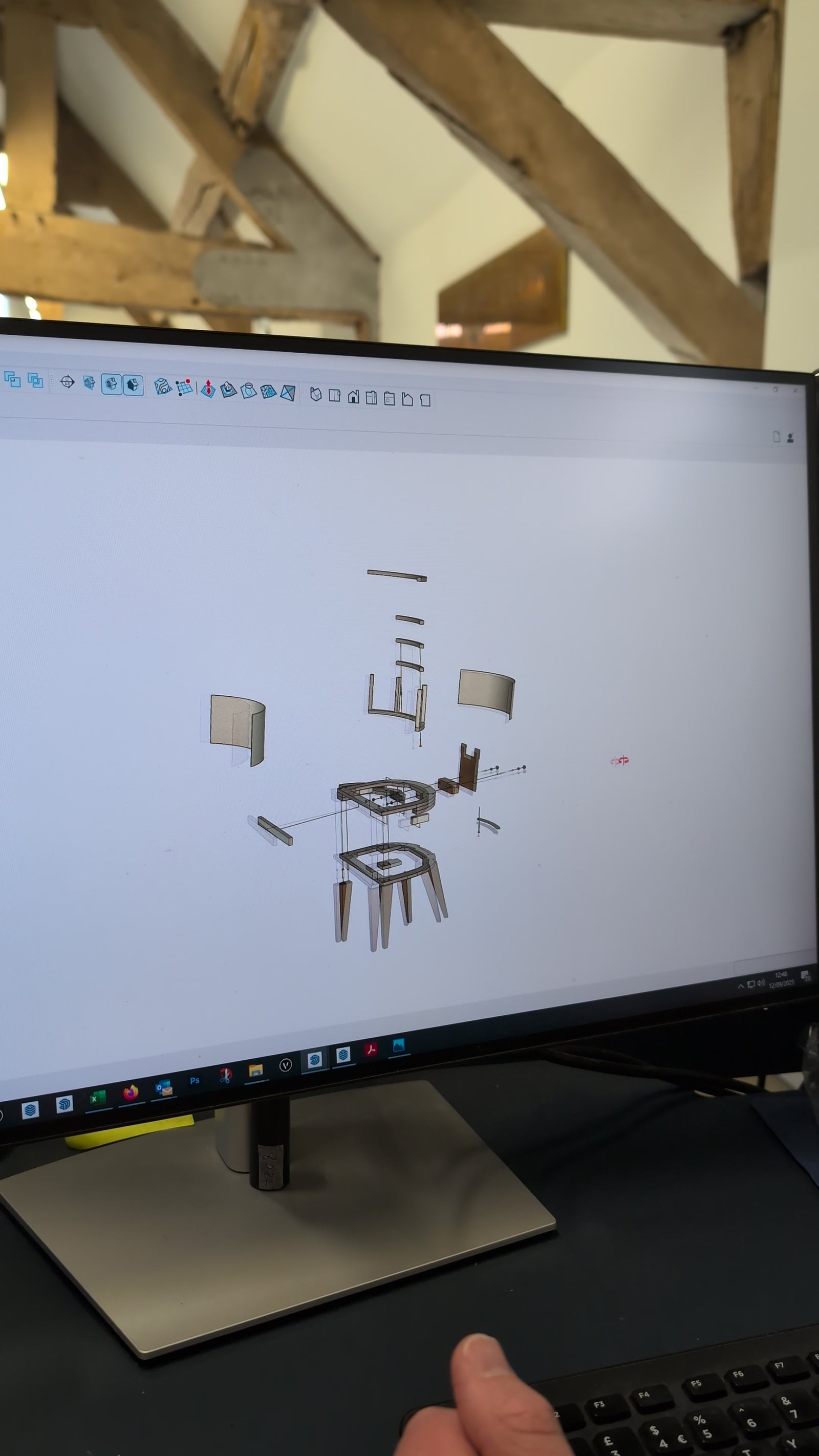Computer screen with dining chair design drawings.