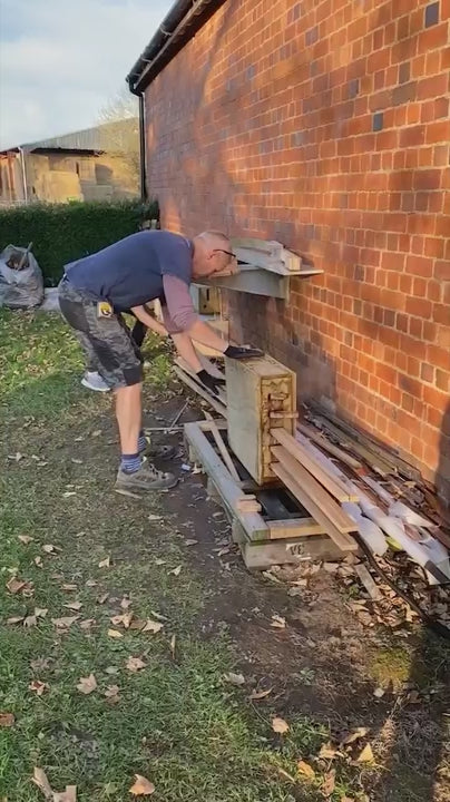 People working outside with wood materials.